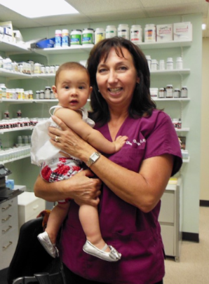 Dr. Tracey holding baby girl