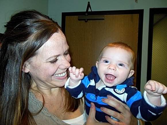 Patient holding her smiling baby boy