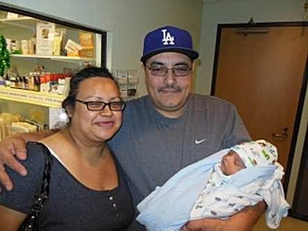 Successful Pregnancy. Man and Woman holding their bundled-up baby