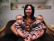 Tracey holding two babies