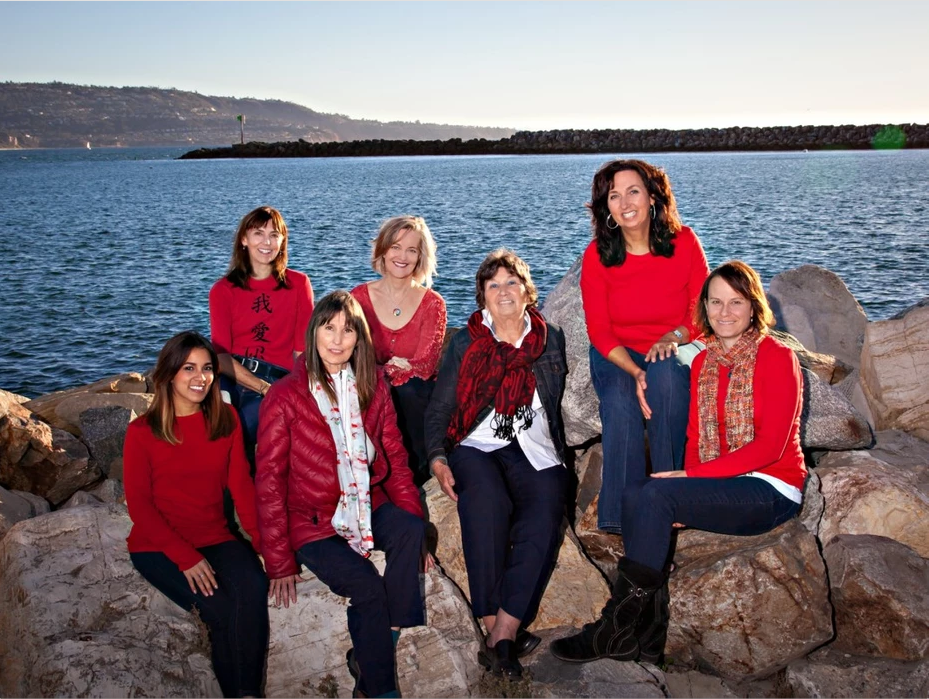 Acupuncture Team sitting on rocks with water in the background